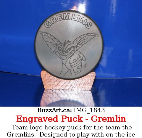 Hockey puck with team Gremlins logo on it